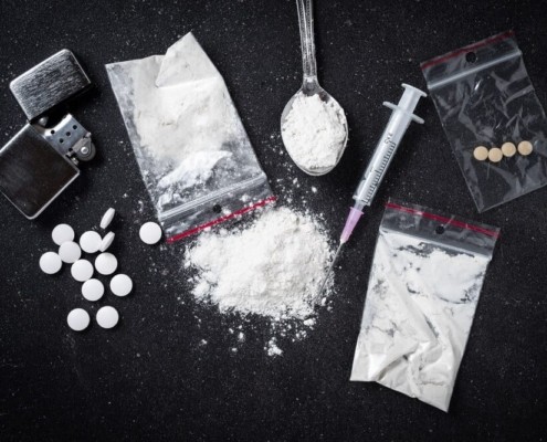 most popular recreational drugs- lighter spoon with cocaine, needle and 4 small pills